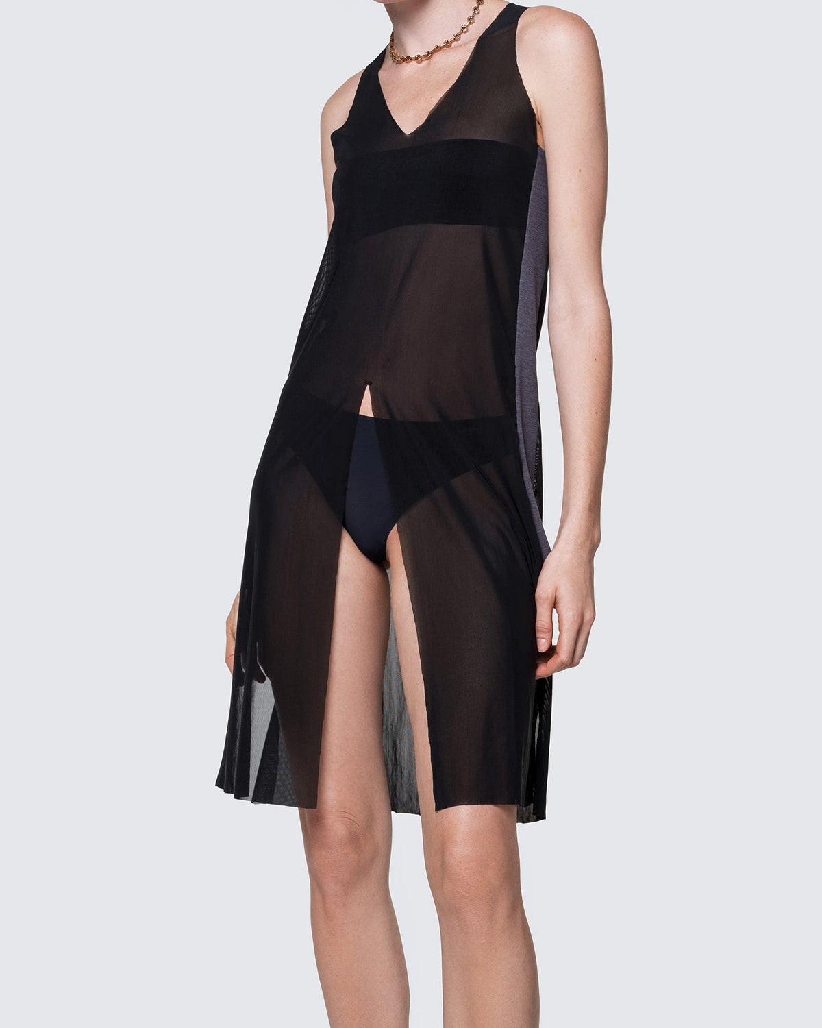 Model wearing the 12Twelve Air Dress in Black, a sheer sleeveless dress with V-neck and fluid drape