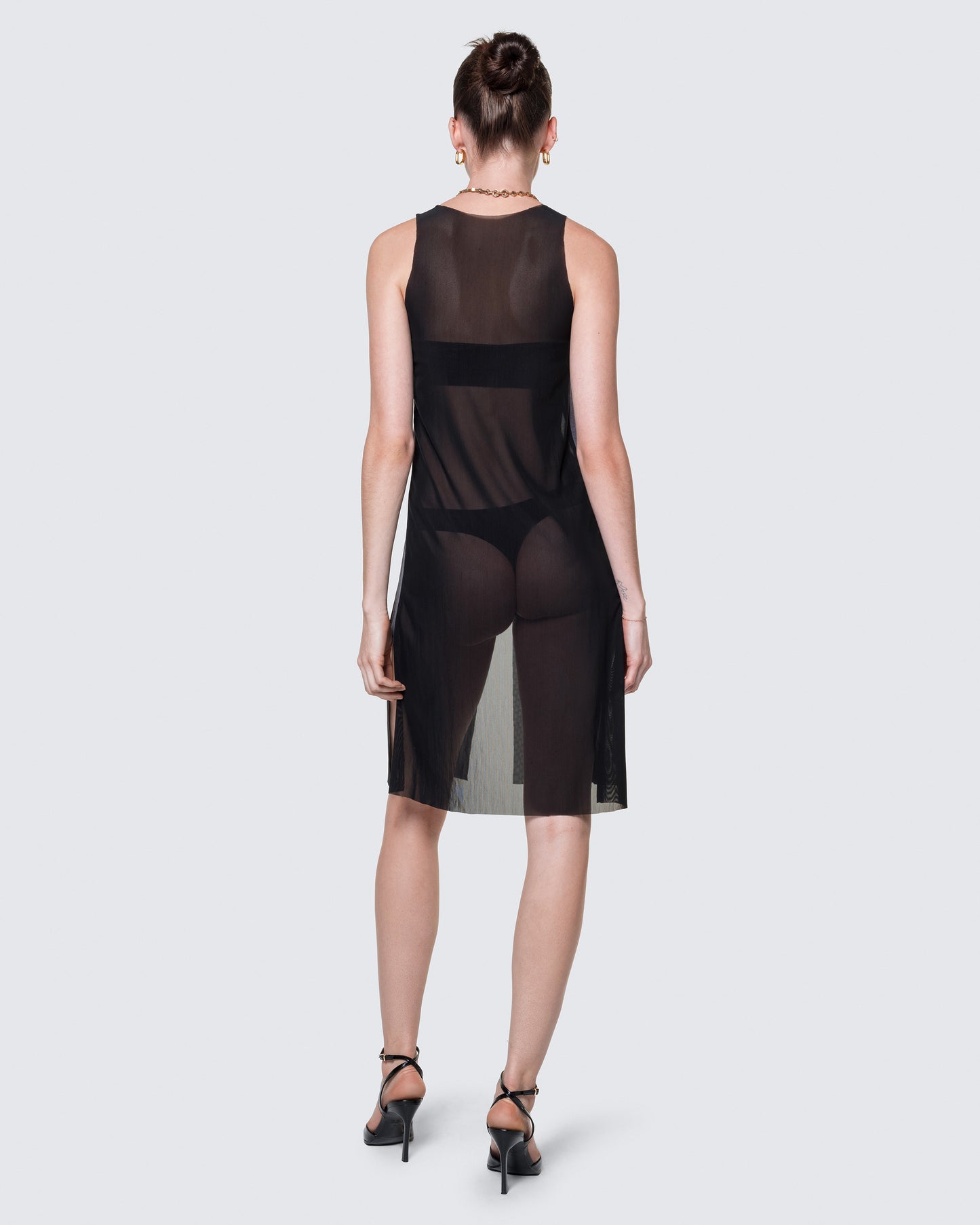 Full-body view of the black 12Twelve Air Dress styled with heels for an elevated minimal look