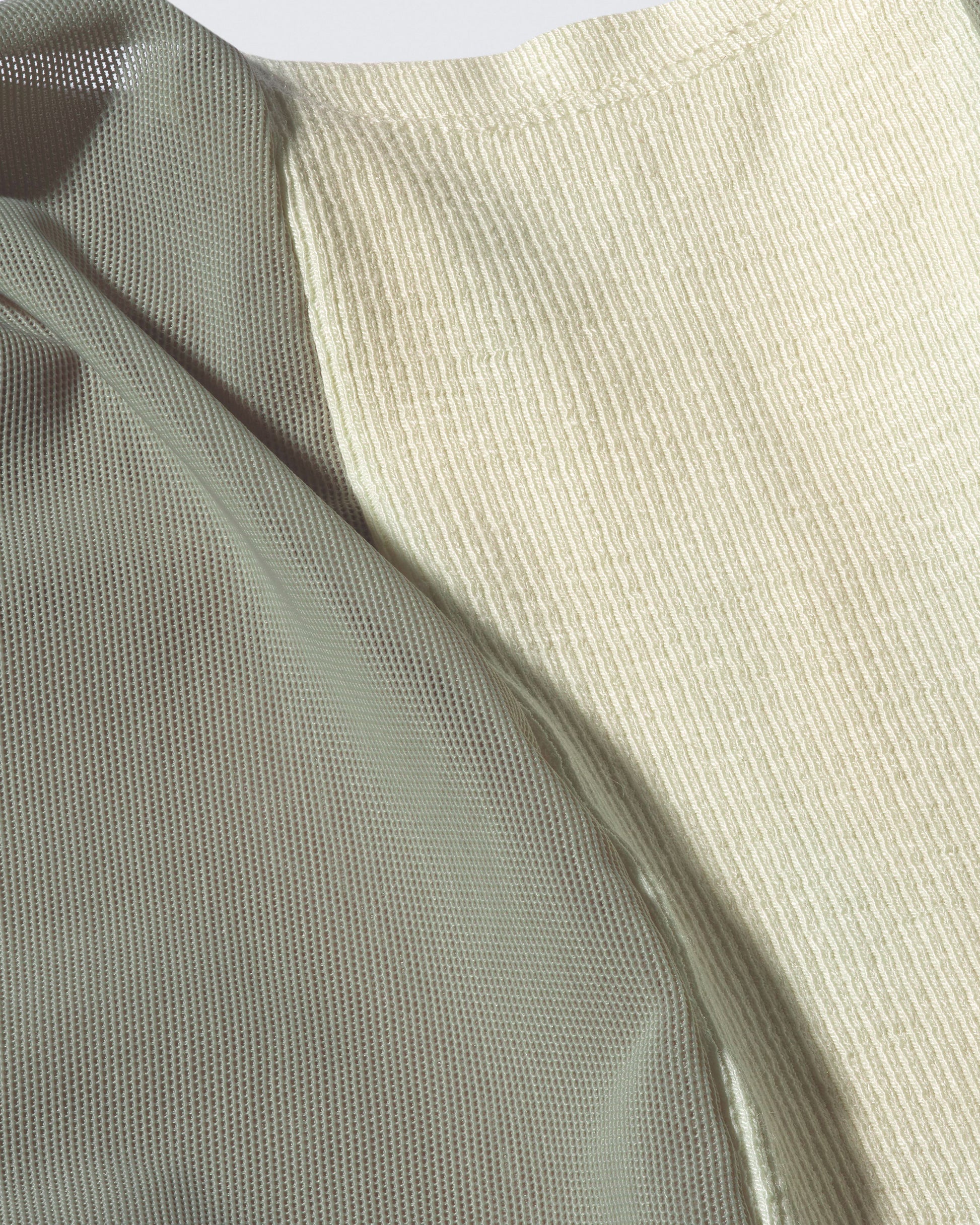 Close-up of sage green sheer fabric used in the lightweight Air Dress by 12Twelve