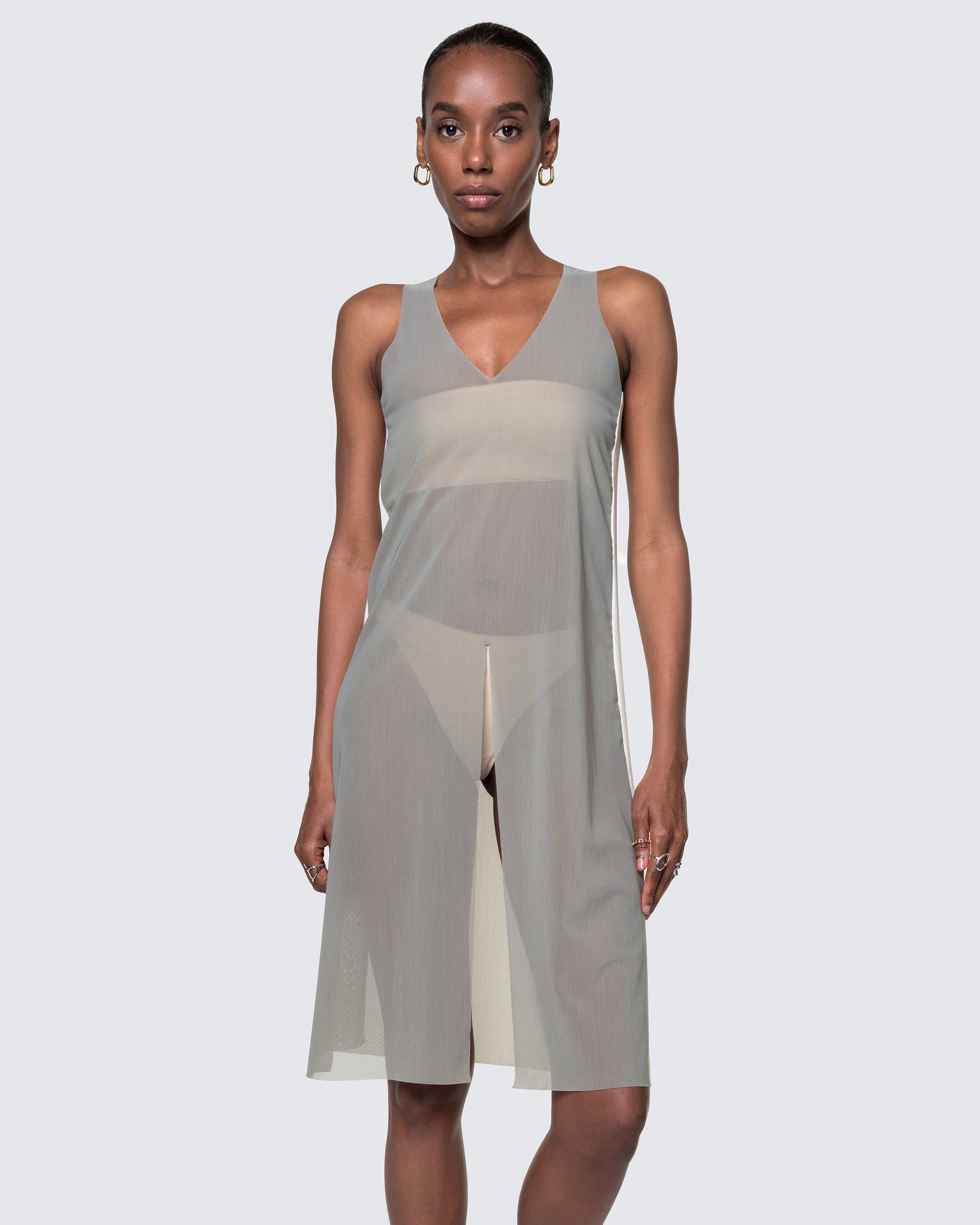 Model wearing the 12Twelve Air Dress in Sage, a sheer sleeveless midi dress with V-neck and flowy fit