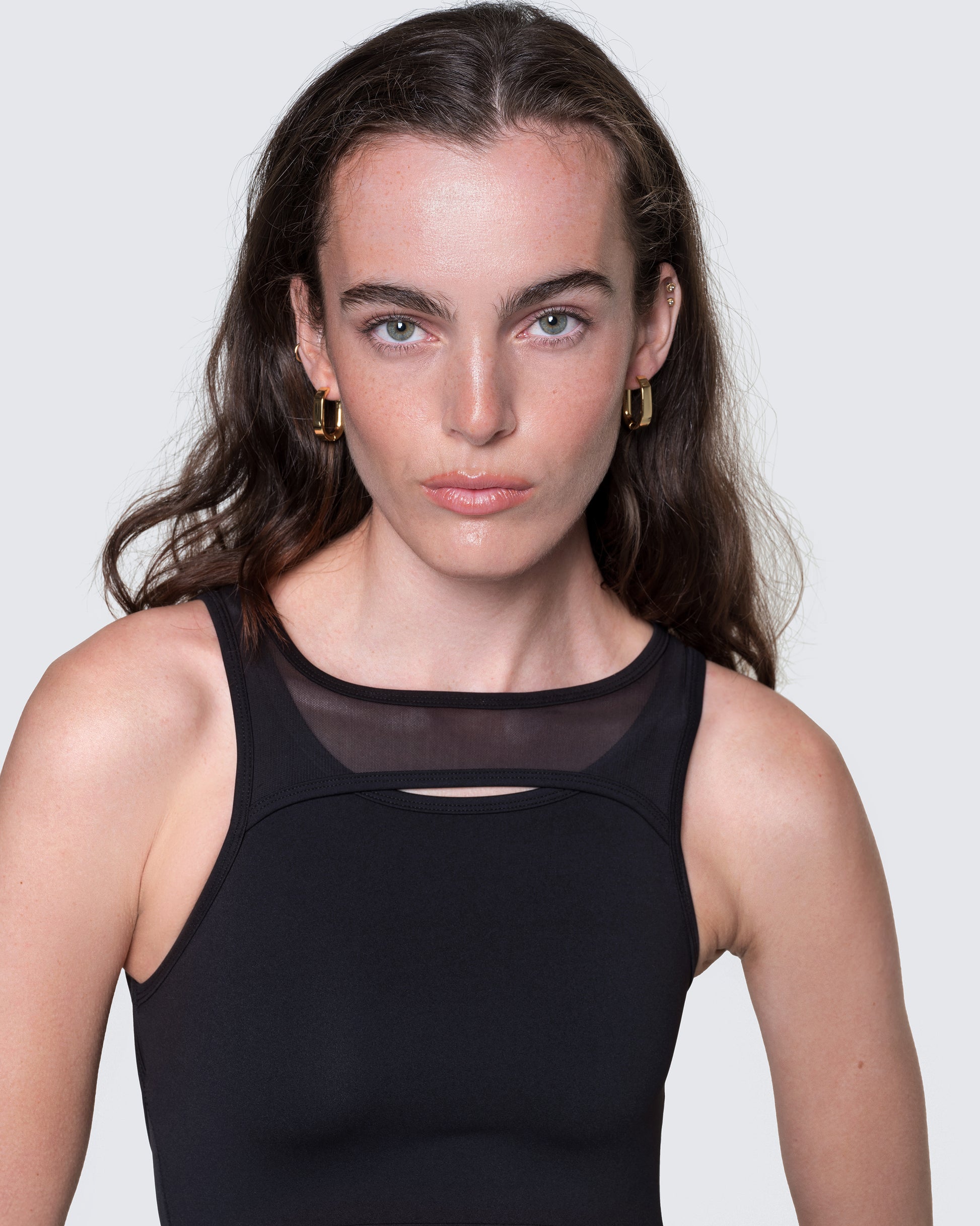 Close-up of 12Twelve bodysuit neckline showing mesh inset and stretch knit fabric