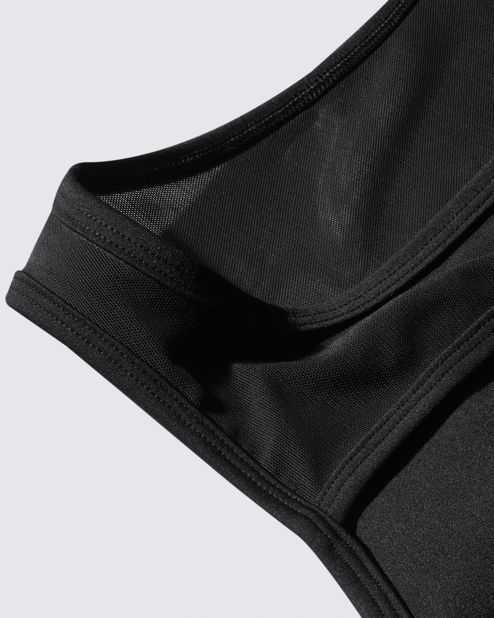 Macro shot of 12Twelve bodysuit fabric showing soft stretch performance knit