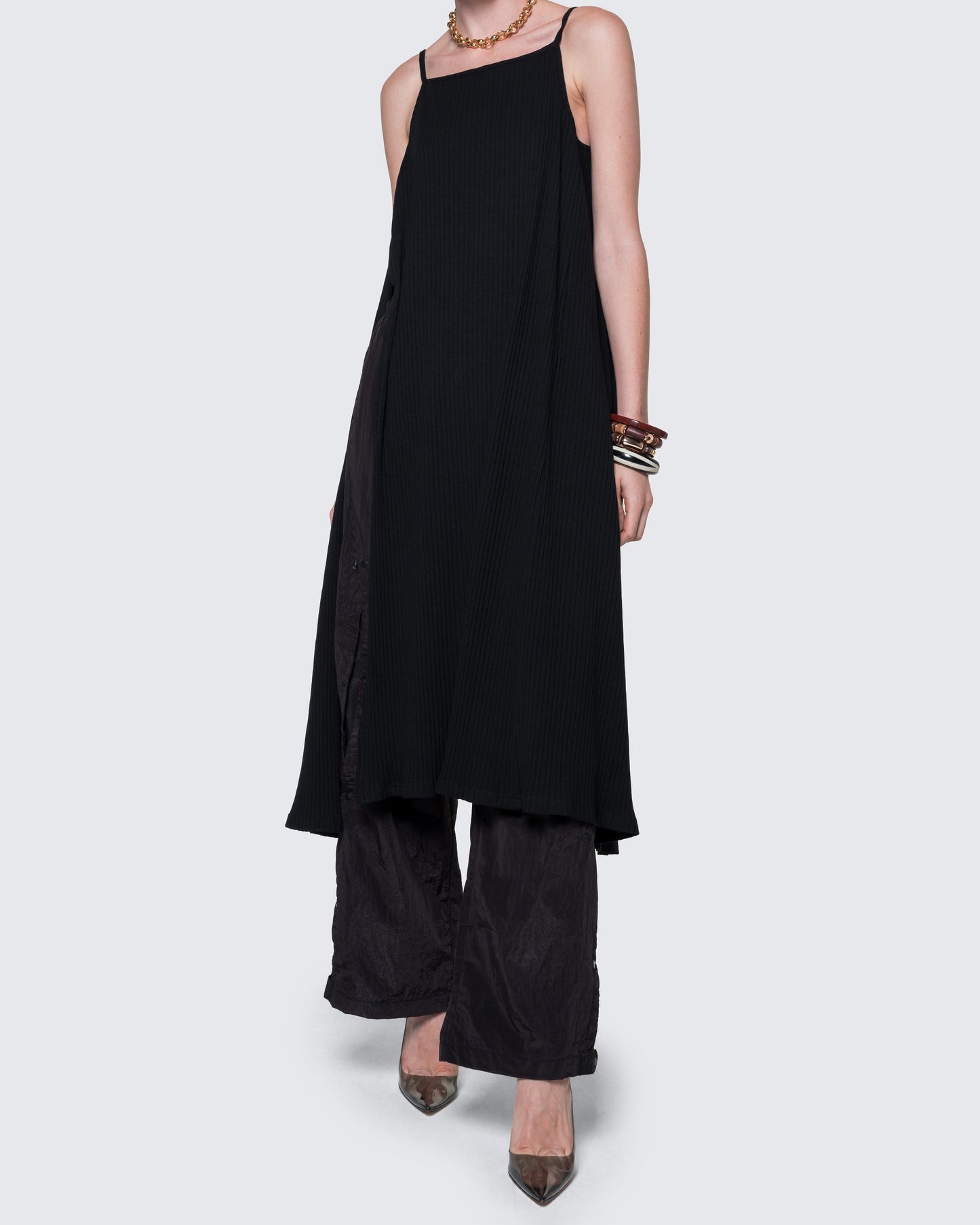 12Twelve black reversible dress styled with pants, showcasing flowy silhouette