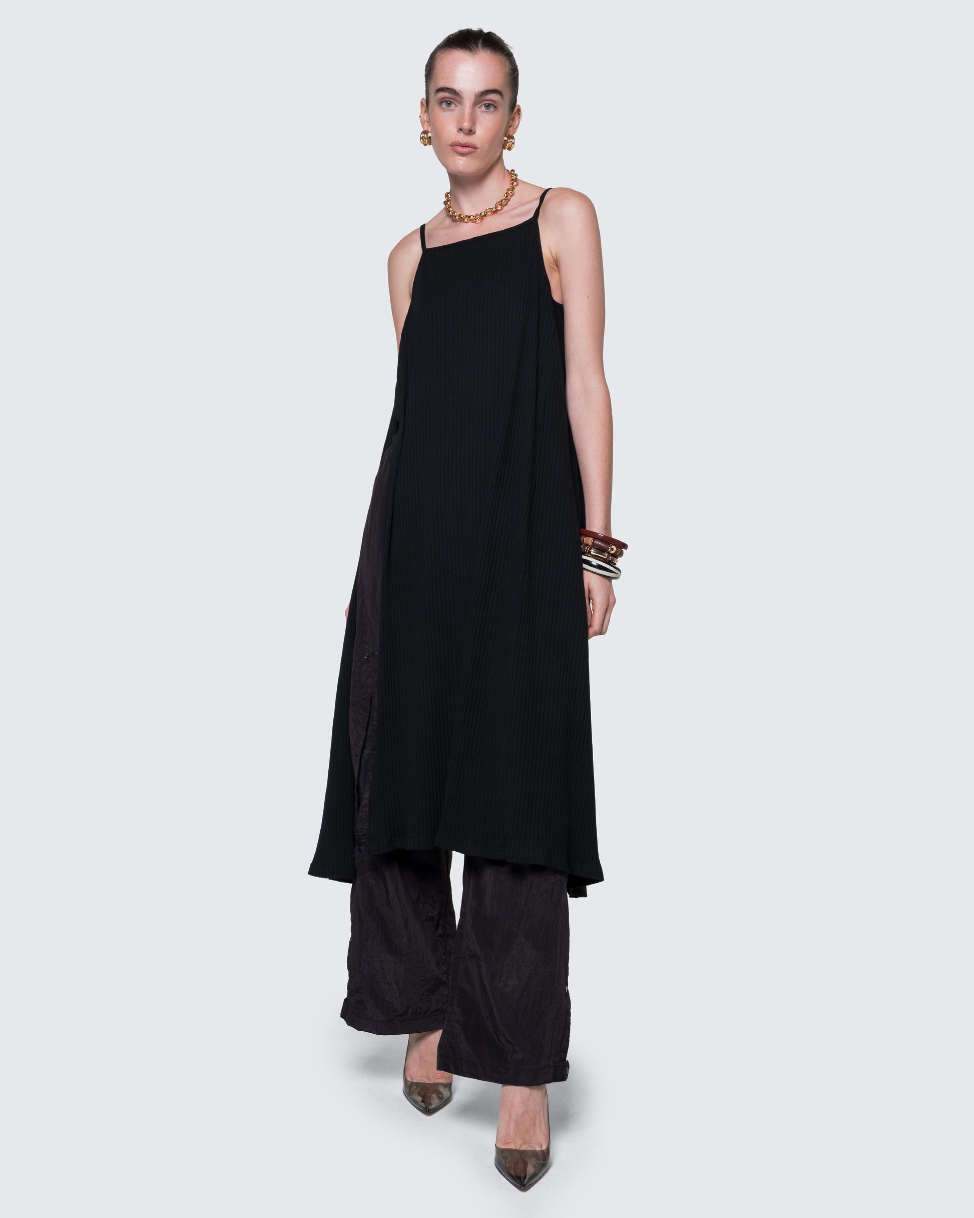 12Twelve black reversible dress styled with pants, showcasing flowy silhouette