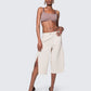Model wearing 12Twelve Ease Short in ivory, high-waisted wide-leg shorts with front slit