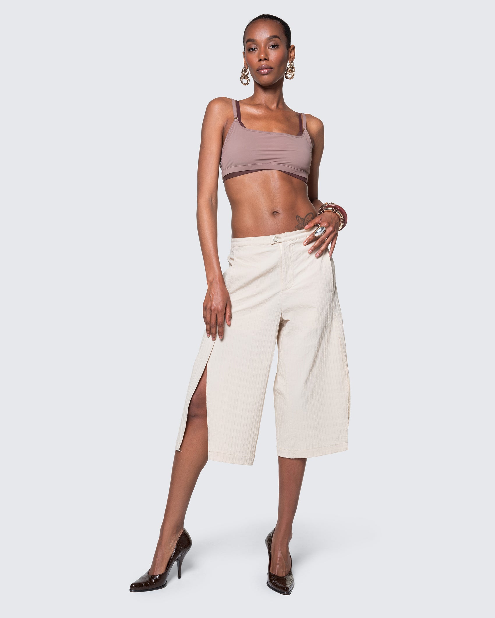 Model wearing 12Twelve Ease Short in ivory, high-waisted wide-leg shorts with front slit