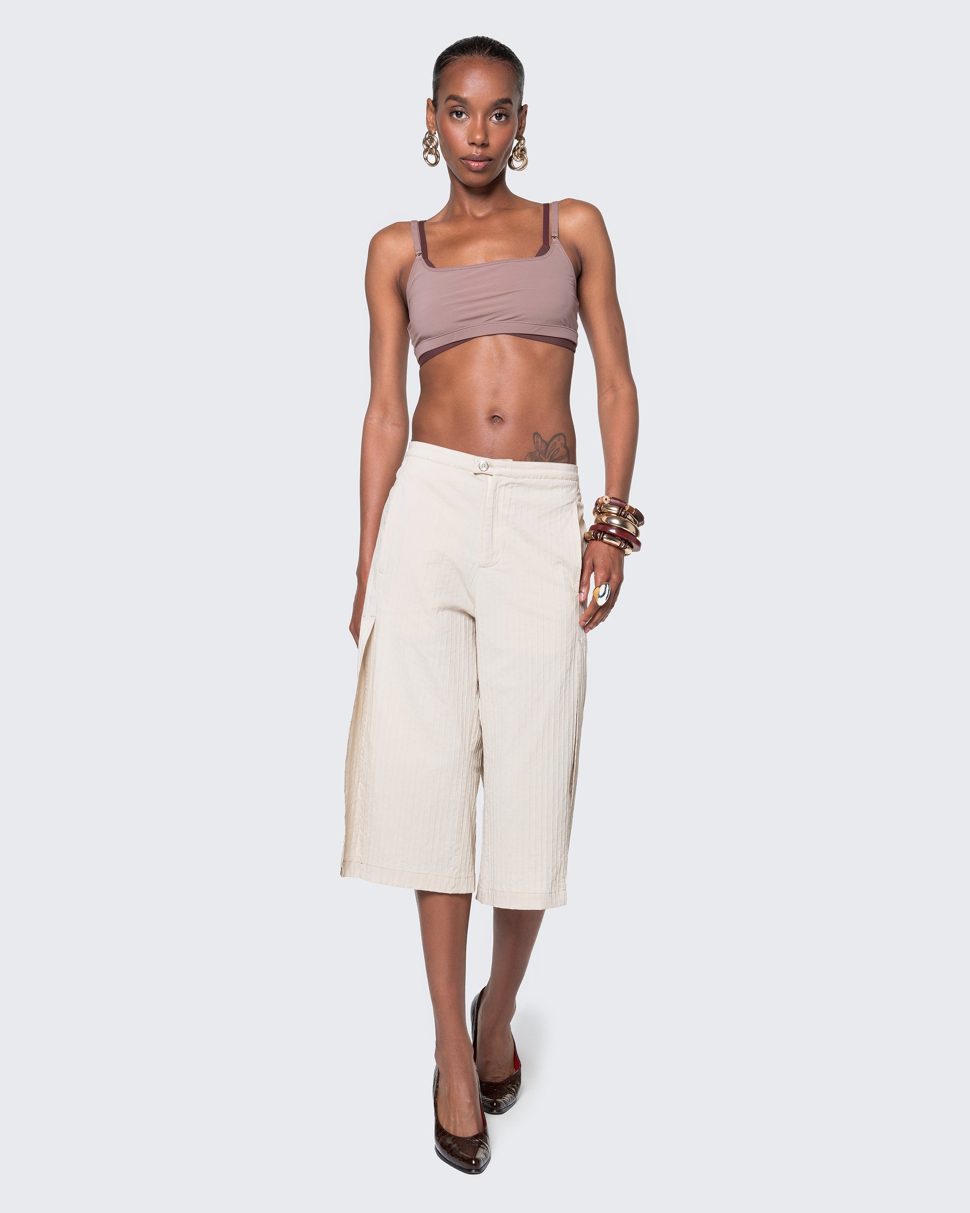 Model walking in 12Twelve Ease Short, styled with crop top and heels