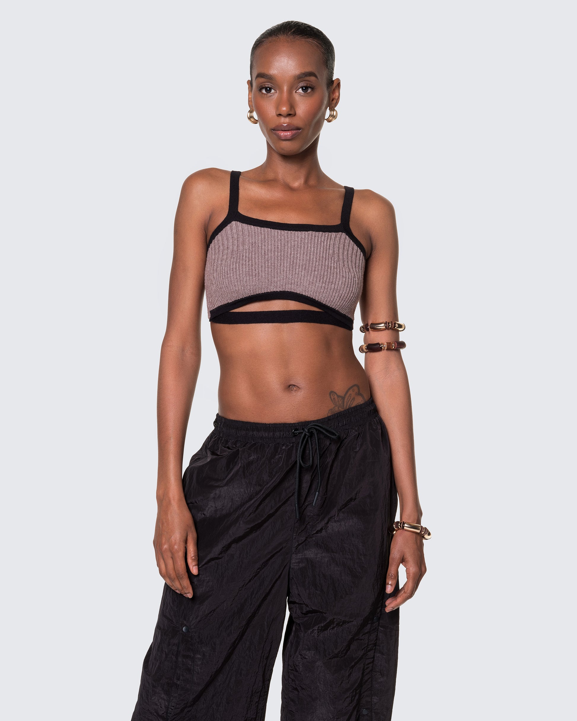 Model wearing 12Twelve Frame Knit crop top in Sienna Clay with wide strap ribbed knit detail