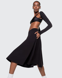 Model wearing 12Twelve Heavenly Skirt in black with asymmetric long sleeve top