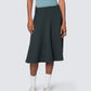 High-waisted emerald green midi skirt styled with sporty top and sneakers