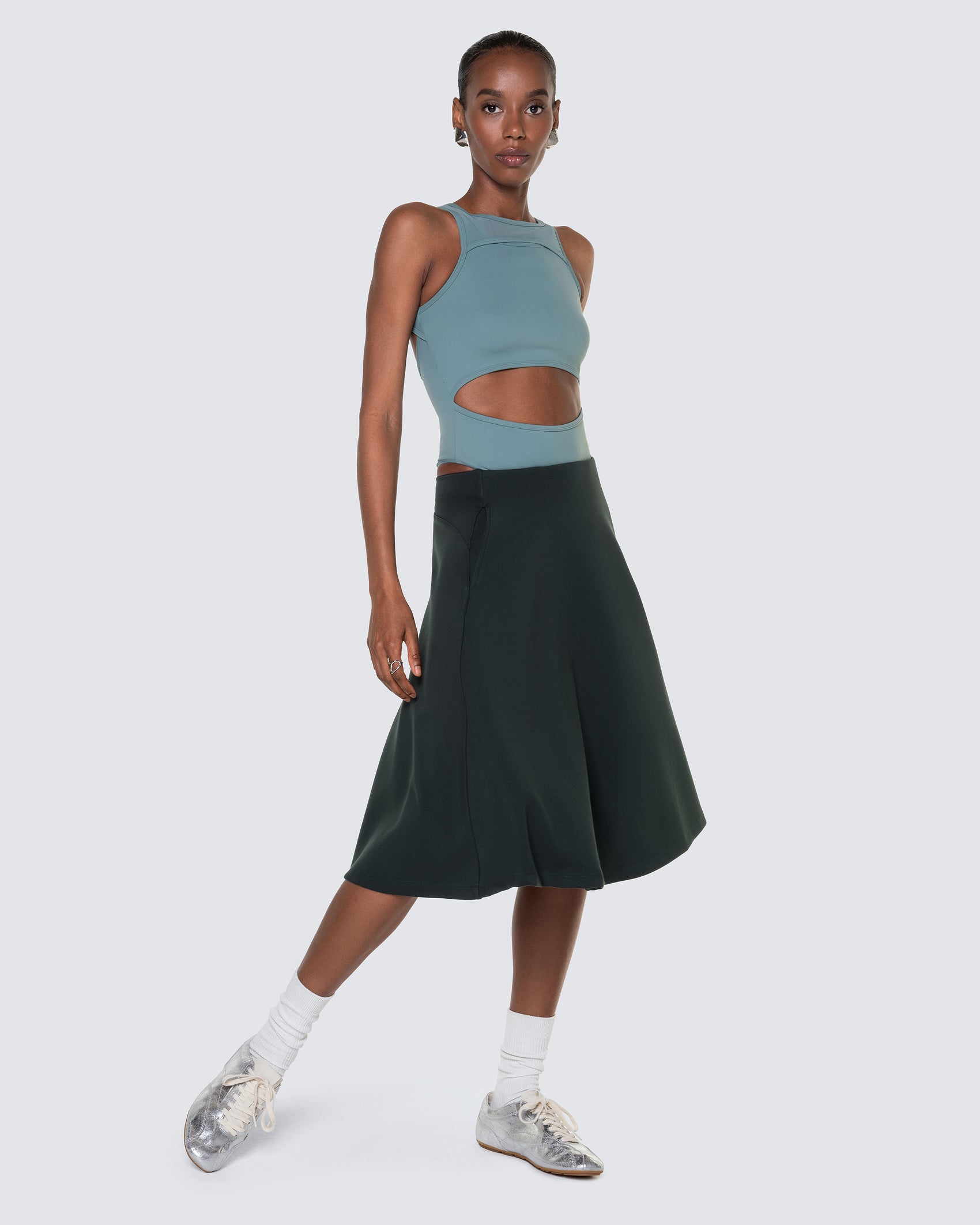 Model wearing 12Twelve Heavenly Skirt in emerald green paired with Tide Blue bodysuit