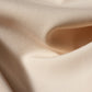 Detail view of bone Form Dress fabric showing stretch crepe texture