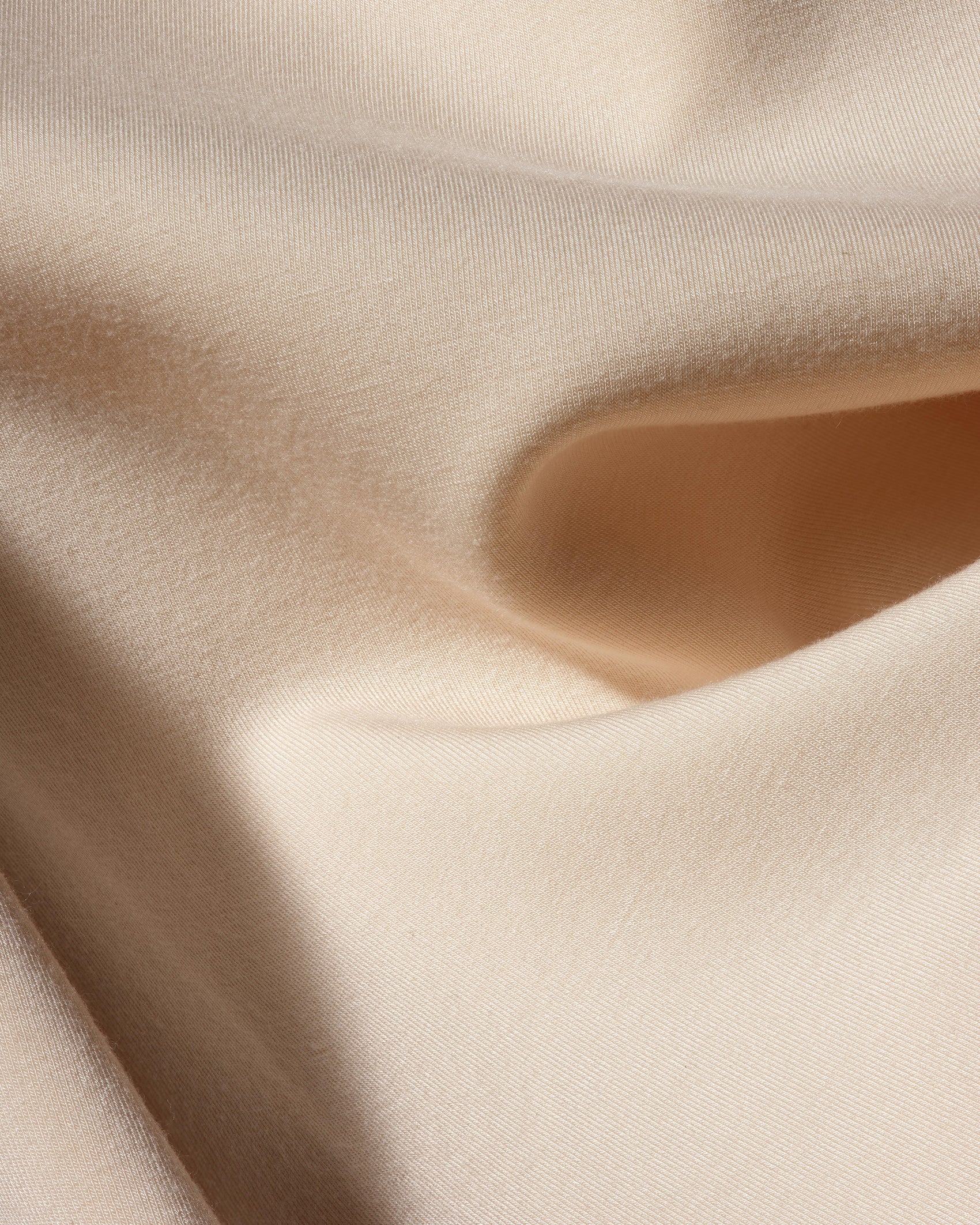 Detail view of bone Form Dress fabric showing stretch crepe texture