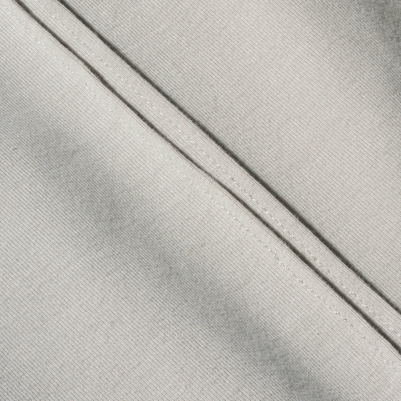 A macro shot of the 12twelve line tee cotton fabric with double seam line detail.