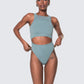 Model wearing 12Twelve tide blue bodysuit with scoop neckline and waist cut-out