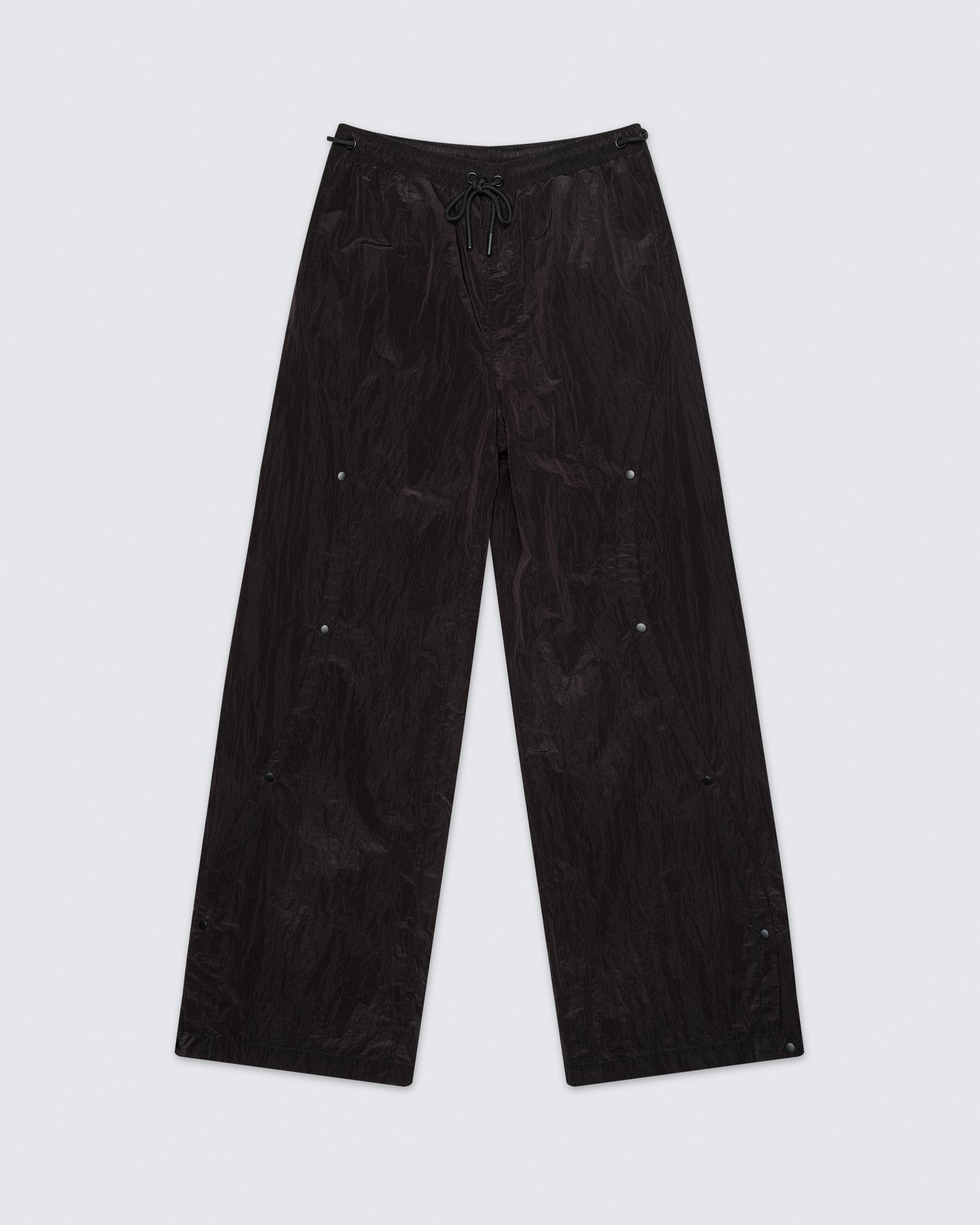 Flat lay of 12Twelve black track pants displaying wide leg silhouette and casual fit design
