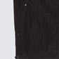 Close-up detail of 12Twelve track pants hem showing fabric texture and snap button hardware