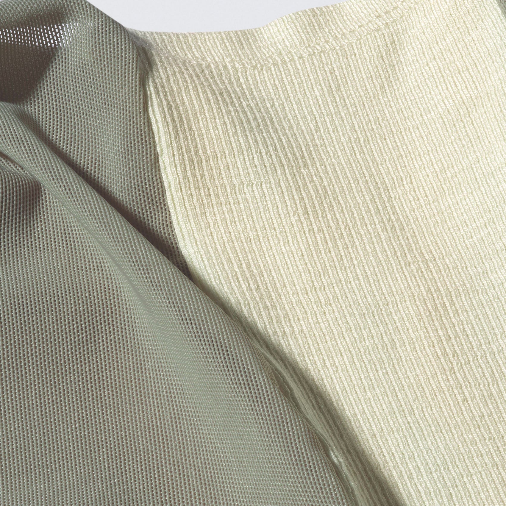 A macro shot of the 12twelve Air Dress mesh and rib knit fabric in sage. 