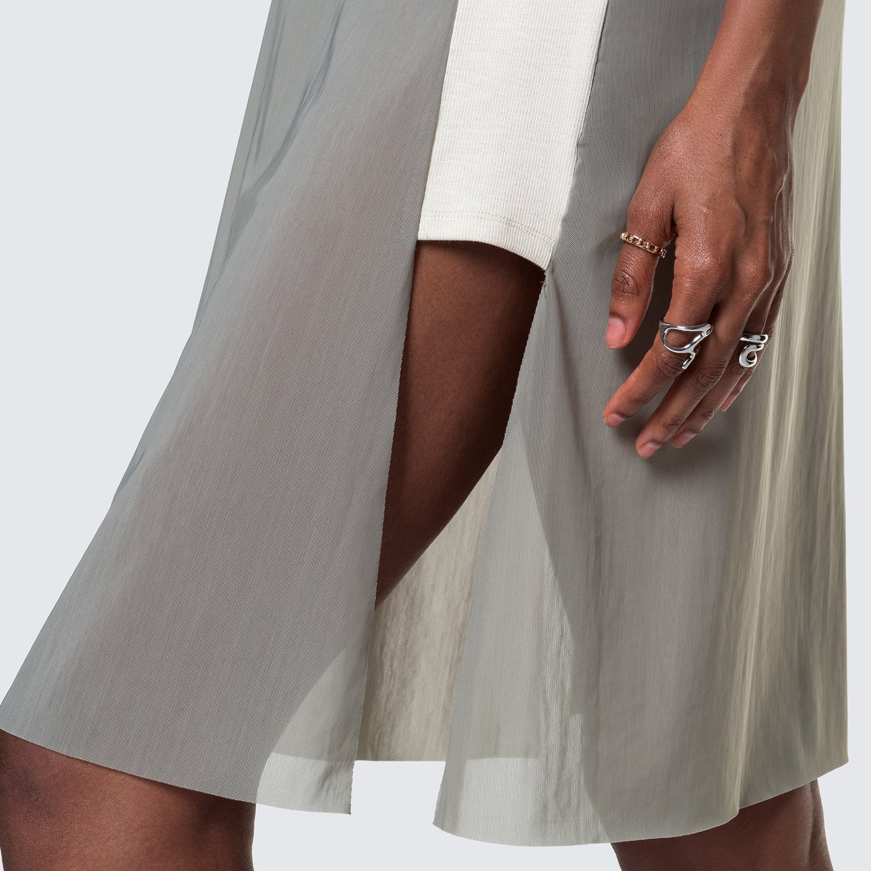 A profile view of the 12twelve AIr Dress showing the raw edge mesh hem and rib knit side panel.