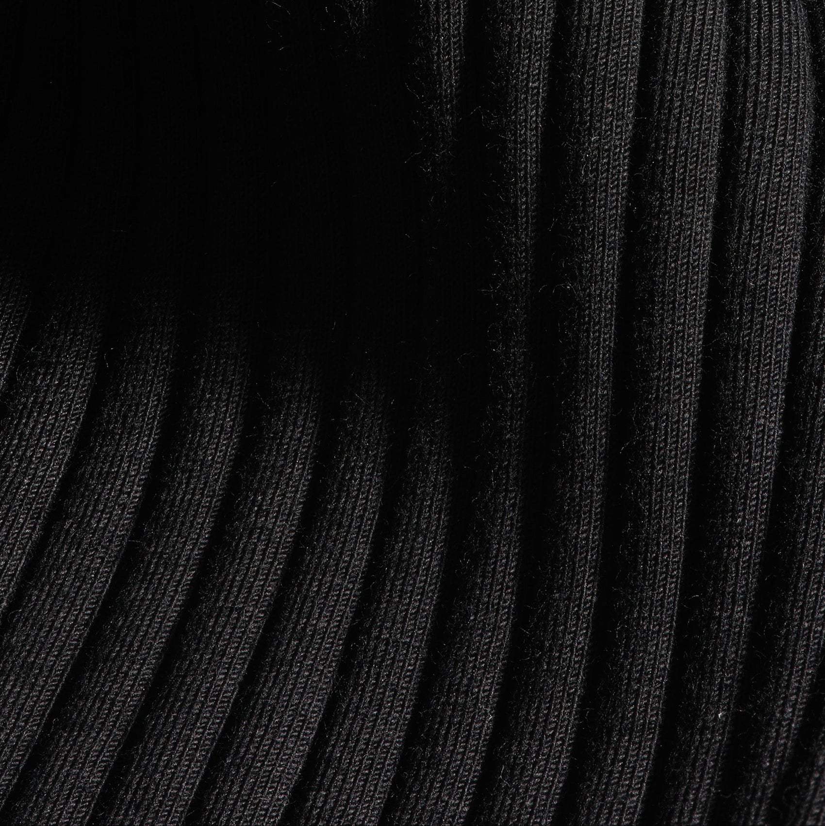 A macro image of the premium ribbed knit fabric from the 12twelve Reversible Wrap Dress. 